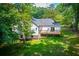 Overhead shot showing the spacious backyard, a wooden deck, and surrounding trees at 4694 E Glen Ridge E Cir, Winston, GA 30187