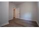 Bedroom featuring wood-look flooring, neutral paint, base molding, and doorway at 4694 E Glen Ridge E Cir, Winston, GA 30187