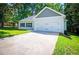 Home exterior showcasing blue shutters, fresh landscaping, two-car garage, and a newly paved driveway at 4694 E Glen Ridge E Cir, Winston, GA 30187