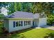 Charming home with blue shutters, gray roof, attached two-car garage, and manicured front lawn at 4694 E Glen Ridge E Cir, Winston, GA 30187