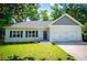 Charming one-story home with a two-car garage, well-manicured lawn, and blue shutters at 4694 E Glen Ridge E Cir, Winston, GA 30187