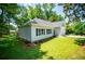 Beautiful home exterior featuring a well-kept lawn, lush landscaping, and a two-car attached garage at 4694 E Glen Ridge E Cir, Winston, GA 30187