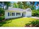Charming home with a well-manicured lawn, blue shutters, a gray roof, and an attached two-car garage at 4694 E Glen Ridge E Cir, Winston, GA 30187