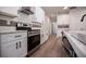 New kitchen showcasing stainless steel appliances, white cabinets with black hardware, and a light stone countertops at 4694 E Glen Ridge E Cir, Winston, GA 30187