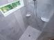New shower featuring light colored walls, mosaic accents, and white shelves at 4694 E Glen Ridge E Cir, Winston, GA 30187