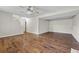 Open basement area with hardwood floors, ceiling fan and lots of potential for a custom buildout at 5399 Kristian Ct, Stone Mountain, GA 30088