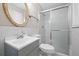 Bright bathroom featuring updated vanity, mirror, and a shower with sliding glass door at 5399 Kristian Ct, Stone Mountain, GA 30088