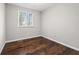 Cozy bedroom features hardwood floors, one window for natural light, and neutral wall paint at 5399 Kristian Ct, Stone Mountain, GA 30088