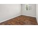 Bedroom with hardwood floors, one window with coverings, and baseboard trim at 5399 Kristian Ct, Stone Mountain, GA 30088