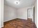 Bedroom showcasing wood-look floors, baseboard trim, and open door with bathroom view at 5399 Kristian Ct, Stone Mountain, GA 30088