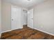 Cozy bedroom with hardwood floors, neutral paint, and two white doors at 5399 Kristian Ct, Stone Mountain, GA 30088