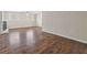 Spacious living room with wood-look floors, fireplace, two windows, and beadboard wainscoting at 5399 Kristian Ct, Stone Mountain, GA 30088
