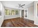 Sunroom with hardwood floors, ceiling fan, and lots of natural light from the many surrounding windows at 5399 Kristian Ct, Stone Mountain, GA 30088
