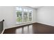 Inviting bedroom featuring hardwood floors and large windows with natural light at 687 Avondale Creek Dr, Decatur, GA 30032