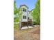 Rear exterior of the two-story home with wooden deck and brick foundation at 687 Avondale Creek Dr, Decatur, GA 30032