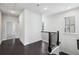 Upstairs hallway featuring hardwood floors and a decorative staircase at 687 Avondale Creek Dr, Decatur, GA 30032