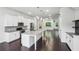 Modern kitchen with large island, white cabinetry, stainless steel appliances, and hardwood floors at 687 Avondale Creek Dr, Decatur, GA 30032