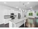 Modern kitchen with large island, white cabinetry, stainless steel appliances, and hardwood floors at 687 Avondale Creek Dr, Decatur, GA 30032