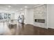 Bright living room featuring a fireplace, hardwood floors, and view of kitchen at 687 Avondale Creek Dr, Decatur, GA 30032
