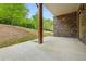 Covered patio with exposed support beam and brick siding at 687 Avondale Creek Dr, Decatur, GA 30032