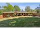 Expansive backyard featuring lush green lawn and a screened porch at 1110 Tuxedo Dr, Roswell, GA 30075