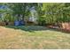 Well-manicured backyard featuring a storage shed and mature trees at 1110 Tuxedo Dr, Roswell, GA 30075
