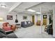 Spacious finished basement with comfortable seating, light colored carpet, and decorations such as a guitar at 1110 Tuxedo Dr, Roswell, GA 30075