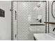 Close up on shower area with white subway tiles, glass enclosure, and black fixtures at 1110 Tuxedo Dr, Roswell, GA 30075