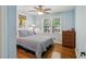 Bedroom features hardwood floors, a ceiling fan, a window, and a closet at 1110 Tuxedo Dr, Roswell, GA 30075