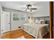 Cozy bedroom with hardwood floors, neutral walls, and a bright window, creating a relaxing retreat at 1110 Tuxedo Dr, Roswell, GA 30075