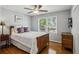Charming bedroom with hardwood floors, ceiling fan, natural light, and classic wood furniture at 1110 Tuxedo Dr, Roswell, GA 30075