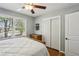 Cozy bedroom featuring hardwood floors, a ceiling fan, and natural light at 1110 Tuxedo Dr, Roswell, GA 30075