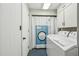 Functional laundry room with washer, dryer, and storage cabinets, providing convenience and organization at 1110 Tuxedo Dr, Roswell, GA 30075