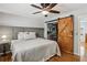 Comfortable bedroom with hardwood floors, natural light, and a sliding barn door to the closet at 1110 Tuxedo Dr, Roswell, GA 30075