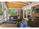 Relaxing screened porch with comfortable wicker furniture and brick accents at 1110 Tuxedo Dr, Roswell, GA 30075