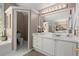 Bathroom featuring a vanity with a large mirror, complemented by a tub and toilet at 2130 Federal Rd, Roswell, GA 30075