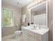 Bathroom with ample natural light, features a toilet and vanity with ample counter space at 2130 Federal Rd, Roswell, GA 30075
