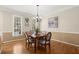 Traditional dining room with hardwood floors, natural light and elegant lighting fixture at 2130 Federal Rd, Roswell, GA 30075