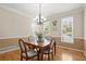 Traditional dining room with hardwood floors, natural light and elegant lighting fixture at 2130 Federal Rd, Roswell, GA 30075