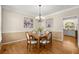 Traditional dining room with hardwood floors, natural light and elegant lighting fixture at 2130 Federal Rd, Roswell, GA 30075