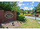 Community entrance featuring a brick sign for Bristol Oaks surrounded by vibrant landscaping at 2130 Federal Rd, Roswell, GA 30075