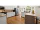 Bright kitchen features white cabinets, stainless steel appliances, and a large island at 2130 Federal Rd, Roswell, GA 30075