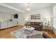 Open-concept living area with hardwood floors, fireplace, and ample seating at 2130 Federal Rd, Roswell, GA 30075