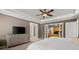 Spacious main bedroom featuring a ceiling fan and tray ceiling detail, complemented by a large dresser for storage at 2130 Federal Rd, Roswell, GA 30075
