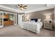 Comfortable main bedroom with neutral carpeting, features a large bed and access to an office space at 2130 Federal Rd, Roswell, GA 30075