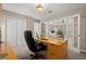 Home office with a large desk and French doors leading to the main bedroom at 2130 Federal Rd, Roswell, GA 30075
