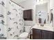 The bathroom features a vanity sink with a dark cabinet and a shower and bathtub at 283 Rosebay Ln, Sharpsburg, GA 30277