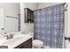 Well-lit bathroom featuring a patterned shower curtain, vanity, and mirror at 283 Rosebay Ln, Sharpsburg, GA 30277