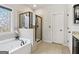Modern bathroom with a soaking tub, glass shower, and vanity at 283 Rosebay Ln, Sharpsburg, GA 30277