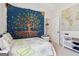 Comfortable bedroom with a tapestry over the bed and a world map at 283 Rosebay Ln, Sharpsburg, GA 30277